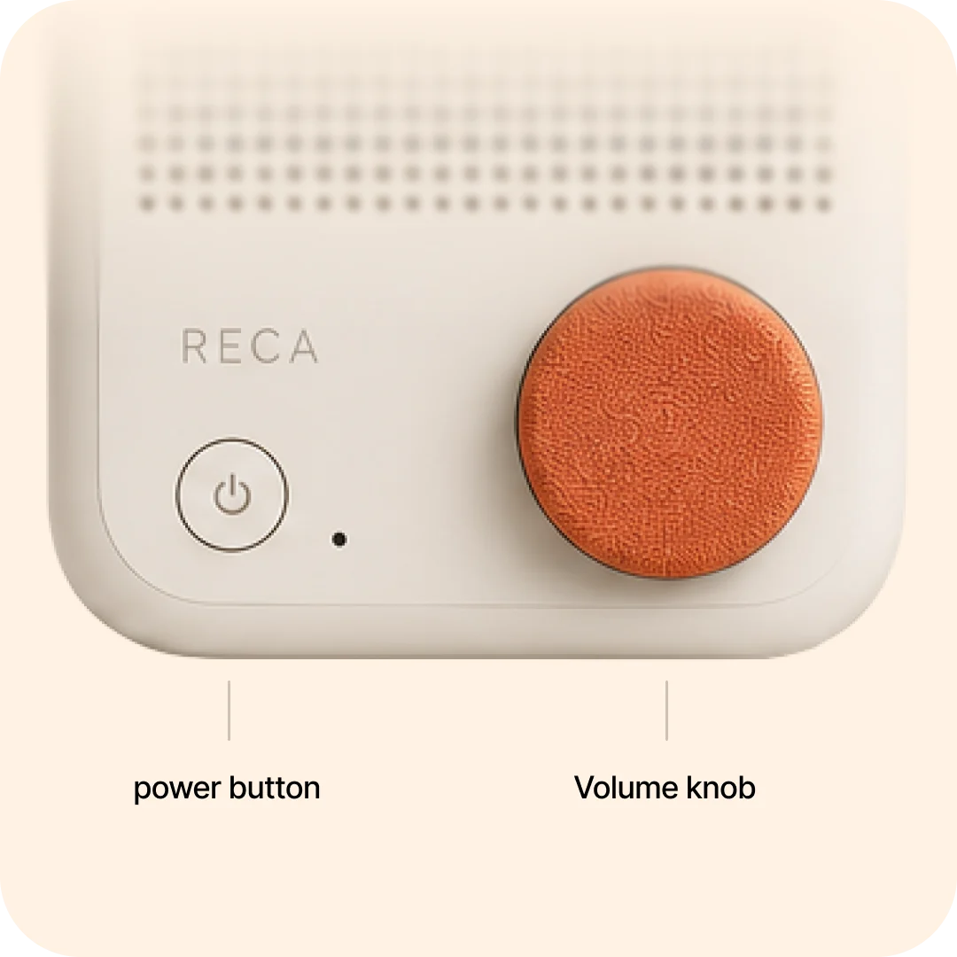 The Reca companion device on a quiet bedside table lit by a warm lamp at night